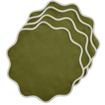 Four green, wavy-edged, circular coasters stacked slightly askew with a white border.