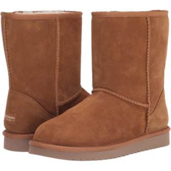 A pair of brown suede winter boots with a fuzzy lining and flat soles. The boots have visible stitching and a simple, unadorned design.