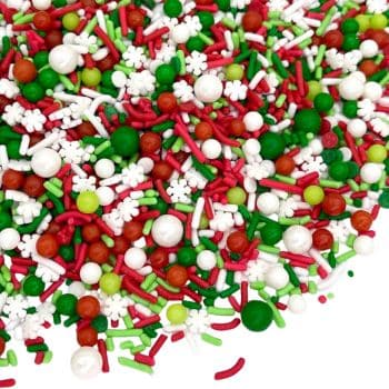 A vibrant array of festive sprinkles, perfect for holiday baking, featuring snowflake shapes and round candies in red, green, and white against a backdrop that beautifully complements chocolate Christmas treats.