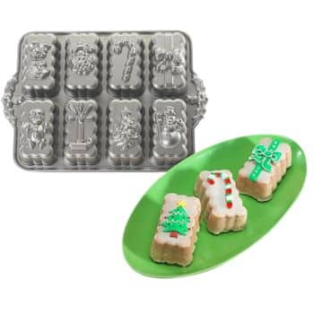 Mini loaf pan with holiday designs including Santa, candy cane, and Christmas tree. Three decorated mini cakes on a green plate, each with festive icing resembling the pan's designs serve as delightful cake inspiration for your seasonal baking adventures.