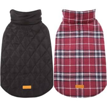 Two dog coats are displayed side by side. The left coat is black with a quilted pattern and a brown tag. The right coat is a red and white plaid design, also featuring a brown tag near the bottom. Both coats have high collars.