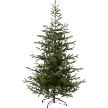 A tall, artificial Christmas tree with green, full branches stands on a metal stand. The tree is unadorned, showcasing its natural appearance.