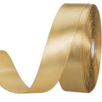 A roll of shiny, golden satin ribbon partially unrolled, with a smooth texture, positioned against a plain white background.