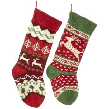 Two colorful Christmas stockings with festive patterns. One has red and green zigzags with reindeer shapes, while the other features red and green with intricate snowflakes and reindeer designs. Both have hanging loops.