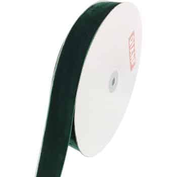 A roll of dark green velvet ribbon is unwound slightly. The ribbon is attached to a white spool with a red label on its side.