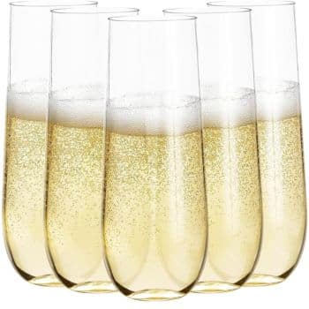 Six champagne flutes filled with bubbly golden champagne, arranged in a neat grouping like a toast to well-loved New Year's recipes. The tall, slender glasses showcase the sparkling effervescence of the drink, capturing the spirit of celebration.