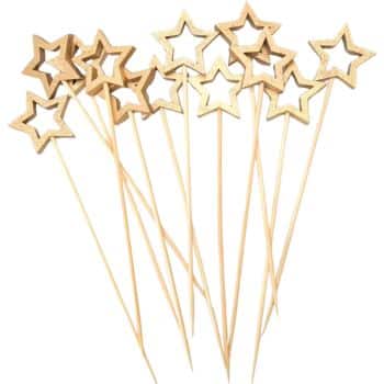 Wooden skewers topped with star-shaped cutouts are arranged in a cluster, perfect for adding a festive touch to your New Year's recipes. The stars have a natural, textured finish, giving them a rustic charm.