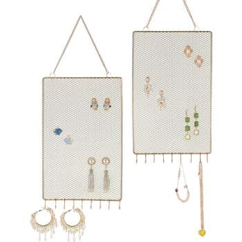 Two rectangular hanging mesh jewelry organizers display various earrings and necklaces. The left organizer features blue and gold earrings, while the right holds green and gold earrings with dangling tassels and charms. Both have chain handles for hanging.