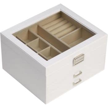 A white jewelry box with a glass lid, featuring compartments for rings and small items. The box has two silver drawer handles for additional storage.