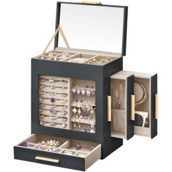 A black jewelry organizer with an open lid revealing a mirrored interior. Multiple compartments hold various pieces of jewelry, including rings, necklaces, earrings, and bracelets. Side panels are open, displaying additional storage.