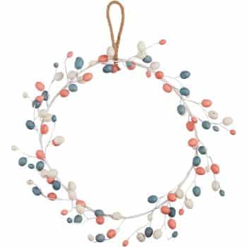 A seasonal wreath crafted from delicate branches, this decorative piece features small, colorful beads in shades of red, blue, and white. It gracefully hangs from a simple brown cord.