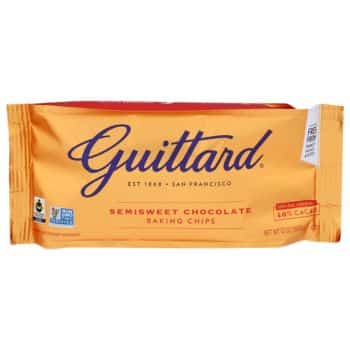 This package of Guittard semisweet chocolate baking chips, flaunting 46% cacao, is perfect for your favorite recipes made with chocolate chips. The gold packaging boasts red and blue text, highlighting its Fair Trade certification and non-GMO verification.