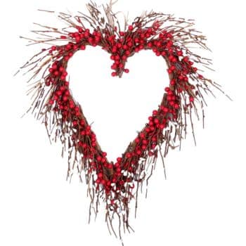 A heart-shaped wreath made of twigs and small red berries, arranged to create an open center. The design is rustic and natural, with a focus on the vibrant red berries contrasting with the brown twigs.