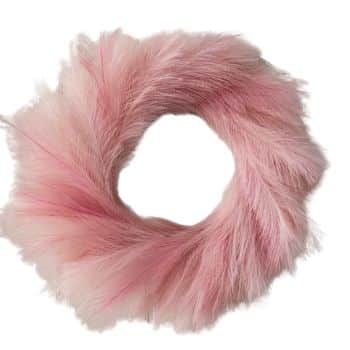 A circular arrangement of fluffy, pink ostrich feathers, forming a soft wreath-like shape against a plain white background.