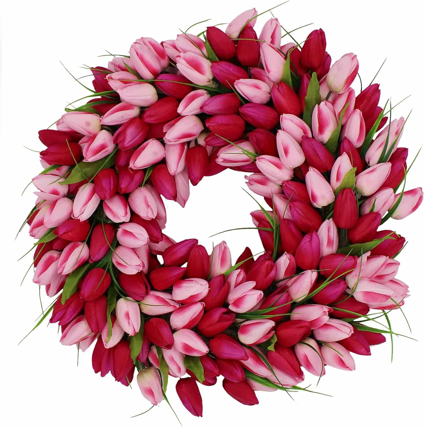 A wreath made of vibrant pink and red tulips, with a lush arrangement of flowers forming a circular pattern. Green leaves are interspersed among the tulips, adding contrast and enhancing the fresh, decorative appearance.