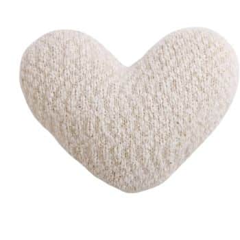 A textured beige heart-shaped pillow against a white background.