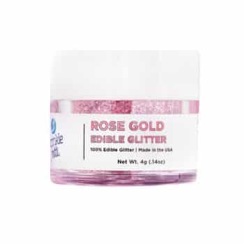 A small container of rose gold edible glitter ideal for enhancing pink desserts. The label reads "Rose Gold Edible Glitter, 100% Edible Glitter, Made in the USA, Net Wt. 4g (0.14oz)." The shimmering pink glitter inside adds a dazzling touch to your treats.