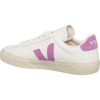 A white sneaker with a purple "V" logo on the side and a purple heel tab featuring the letters "VE." The shoe has white laces and a beige sole. The design is simple and sporty.