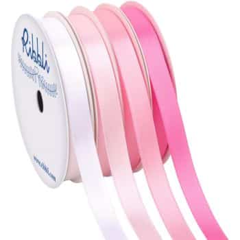 Four spools of ribbon, perfect for pink crafts, in varying shades of pink and white, arranged vertically. Each spool bears the label "Ribbli," and the ribbons are unwound slightly to reveal their smooth texture.