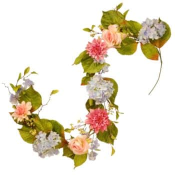 A floral arrangement shaped like the letter "J," featuring pink and blue flowers with green leaves intertwined along the curve and line of the letter.