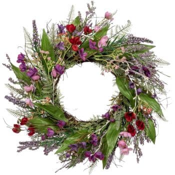 A decorative wreath made of various colorful flowers and green leaves arranged in a circular pattern against a white background. The flowers include shades of red, purple, and pink, with sprigs of lavender and ferns interspersed.