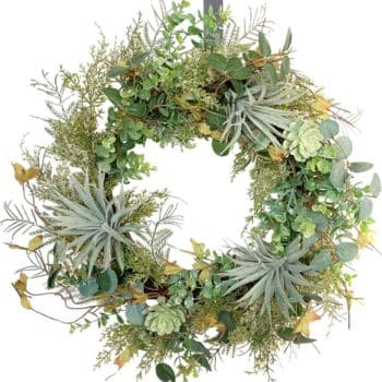 A wreath made of green succulents, ferns, and yellow leaves arranged in a circular pattern, creating a lush and natural display suitable for hanging as a decorative piece.