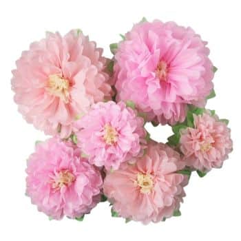 A bouquet of pink, fluffy tissue paper flowers with green accents showcases the art of easy flower paper crafts. Arranged in a cluster, the flowers vary in size and overlap each other, creating a full and vibrant display.