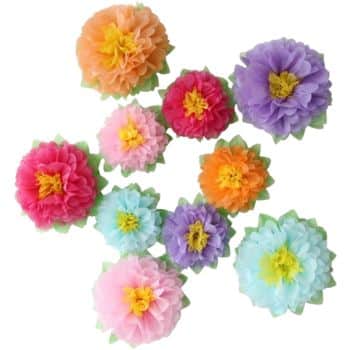 Colorful paper flowers, perfect for easy flower paper crafts, are arranged in a scattered pattern. These vibrant creations vary in colors like orange, pink, purple, blue, and yellow, each boasting a yellow center and a green leafy base.