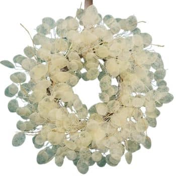 A decorative wreath made of pale green and white translucent leaves, arranged in a circular pattern. The delicate, overlapping leaves create an intricate, airy design, ideal for a natural, serene aesthetic.