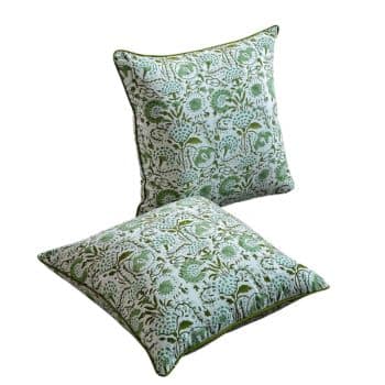 Two square cushions featuring a green and white floral pattern. The design includes intricate leaves and flowers, creating a natural, elegant look. The cushions have piped edges for a finished appearance.