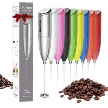 A lineup of colorful handheld milk frothers, including silver, pink, black, green, yellow, and blue—perfect for whipping up the best summer drinks. Scattered coffee beans add charm to the scene. A boxed silver frother with a red bow is also shown.