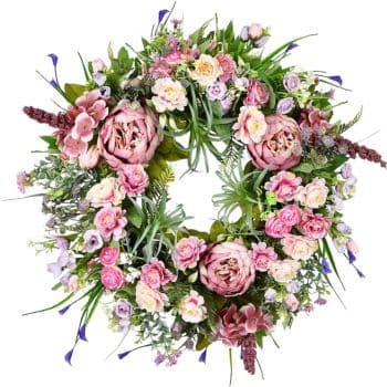 A circular floral wreath with a mix of pink peonies, cream roses, purple flowers, and greenery arranged artistically to form a lush and vibrant decoration.