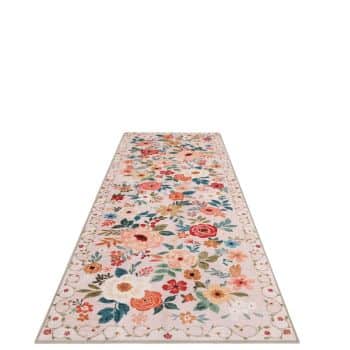 A floral patterned runner rug with a variety of colorful flowers in shades of red, orange, pink, and green on a light background. The border features a simple vine design. The rug tapers off into the distance.