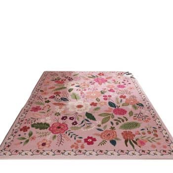 A rectangular pink rug with vibrant floral patterns featuring various flowers and leaves, bordered by a simple decorative edge, set against a plain white background.