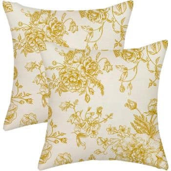 Two decorative pillows with a cream background and intricate yellow floral patterns. The design features detailed flowers and leaves, creating an elegant, vintage look.