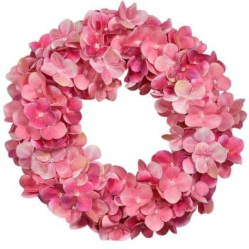 A circular wreath made of vibrant pink hydrangea flowers arranged closely together, creating a lush and colorful floral design. The flowers have delicate petals with subtle variations in pink shades.