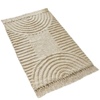 A rectangular beige rug with tassels on the shorter ends. It features textured patterns with semi-circular arcs and straight lines, creating a geometric design.