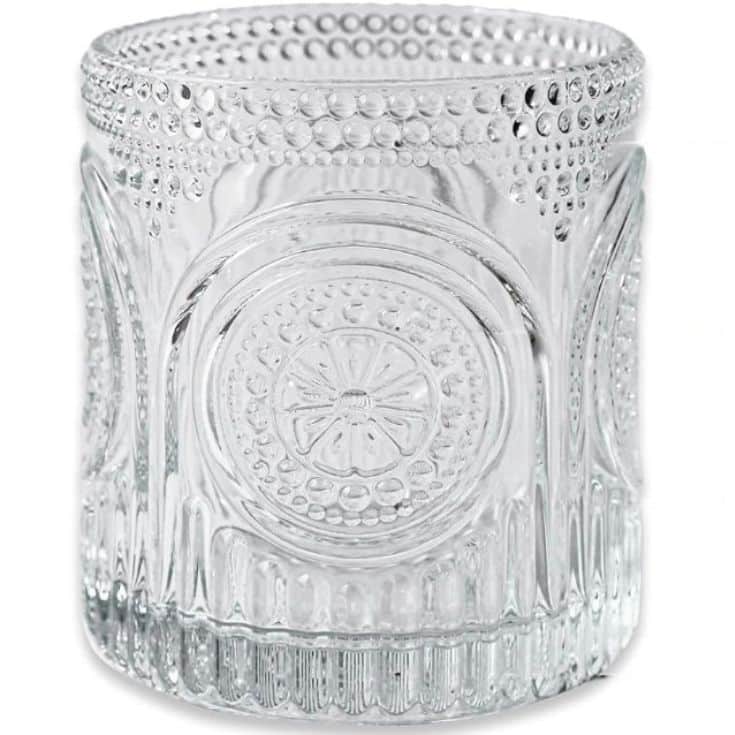 Clear glass tumbler with an ornate, embossed design featuring circular patterns and textured dots around the surface. Perfect for serving a strawberry basil cocktail, the design includes flower-like motifs and intricate detailing, giving an elegant and decorative appearance.