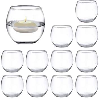 A collection of eleven clear glass round bowls, perfect for my favorite spring crafts. One bowl contains water and a lit white floating candle, creating a serene atmosphere, while the remaining ten are empty and neatly arranged in rows.