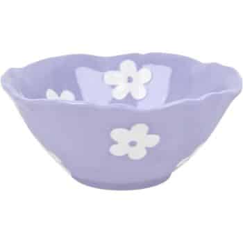 A lavender-colored ceramic bowl with a scalloped edge, featuring white flower designs.