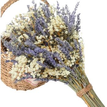 A woven basket holds a rustic bouquet of dried lavender and white baby's breath, tied with twine, creating a natural and charming display.