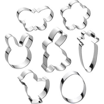 This delightful set of seven silver cookie cutters is perfect for crafting your favorite spring cookies, featuring charming shapes like a butterfly, flower, carrot, oval, chick, bunny head, and full bunny.