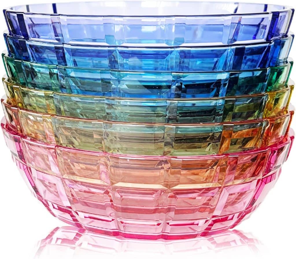 A set of five transparent, stackable bowls in gradient colors—pink, orange, green, blue, and purple—arranged from largest to smallest. Perfect for adding a pop of color to your spring kitchen decor.