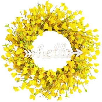 A circular wreath made of bright yellow flowers with green stems, featuring a white arrow-shaped sign in the center that reads "hello" in cursive letters.
