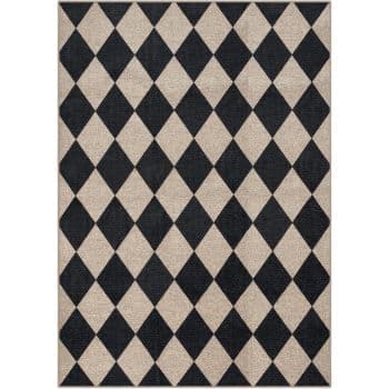Rectangular rug with a black and beige harlequin diamond pattern, featuring alternating dark and light diamonds arranged in straight rows across the surface.