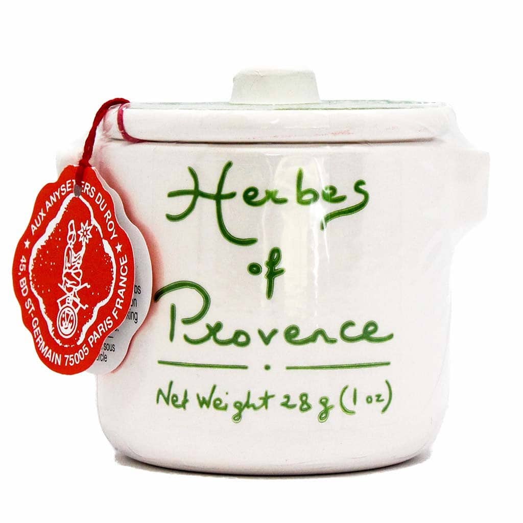 A white ceramic pot labeled "Herbes of Provence" in green script features a red wax seal and an "Alziari-Aux Saveurs Du Pot" tag. Perfect for learning how to make a tender juicy steak. Net weight: 28g (1oz).