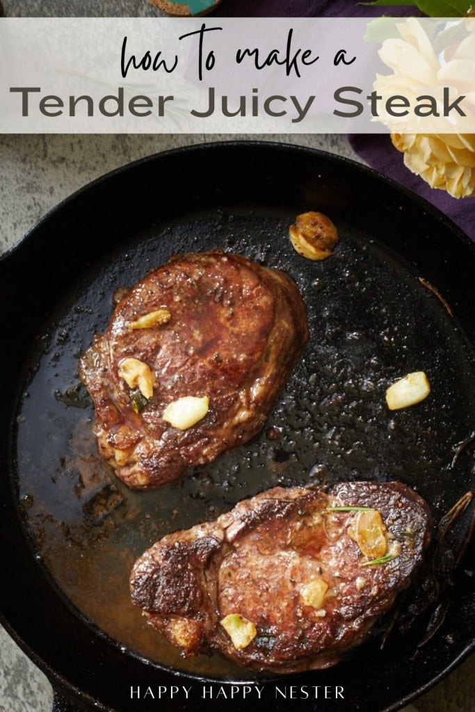 Two cooked steaks with garlic slices sizzle in a black cast iron skillet. Text at the top reads, "How to make a Tender Juicy Steak," sharing tips for how to make a tender juicy steak. Bottom text says, "Happy Happy Nester.