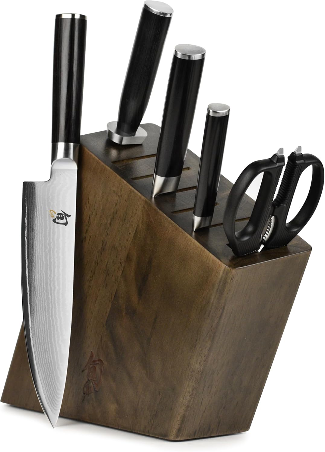 A set of kitchen knives and scissors with black handles, stored in a wooden knife block. One chef’s knife is positioned partially out of the block, displaying its patterned blade—perfect for learning how to make a tender juicy steak.