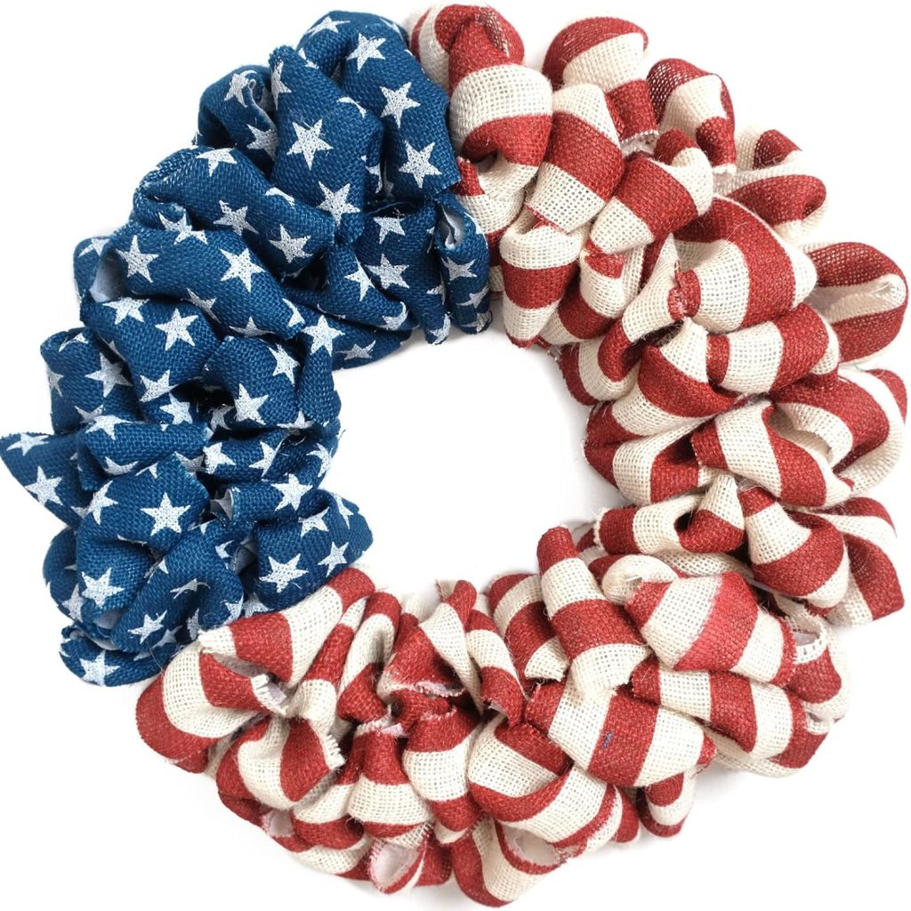 A scrunchie designed with the American flag pattern, featuring blue fabric with white stars on one side and red and white stripes on the other—perfect for pairing with 4th of July wreaths for a festive, patriotic look.
