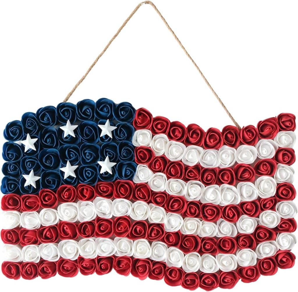 A decorative American flag made of red, white, and blue ribbon roses, with white stars on the blue roses, hanging by twine—perfect for adding patriotic flair to your 4th of July wreaths.